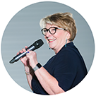 Image of Pauline Daniels holding a microphone