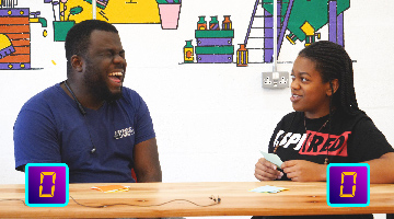 Laughing students sitting at a table.