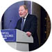 Roger Phillips standing at a podium delivering his lecture